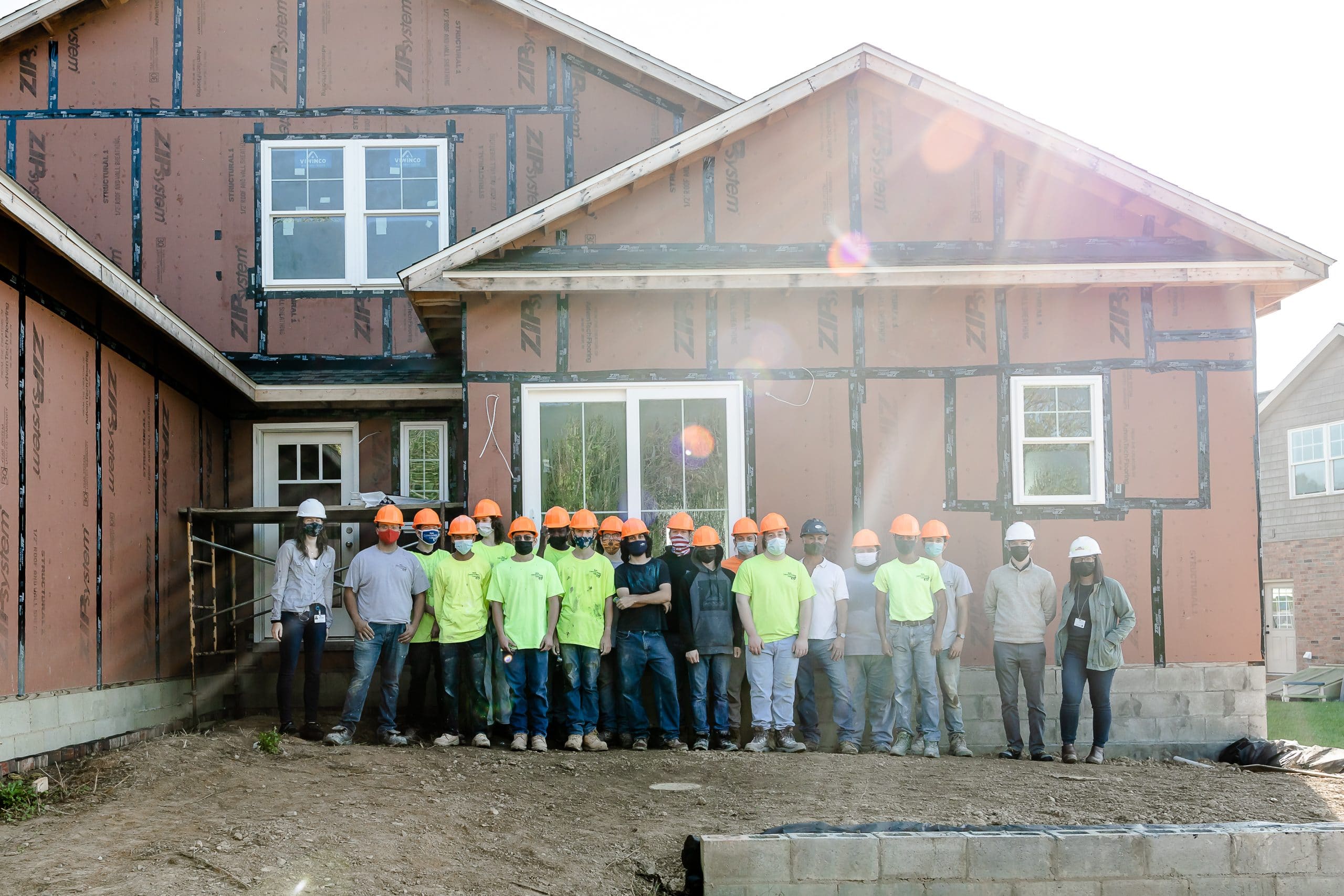 Team of BCTC students posing in front of mid-construction home.