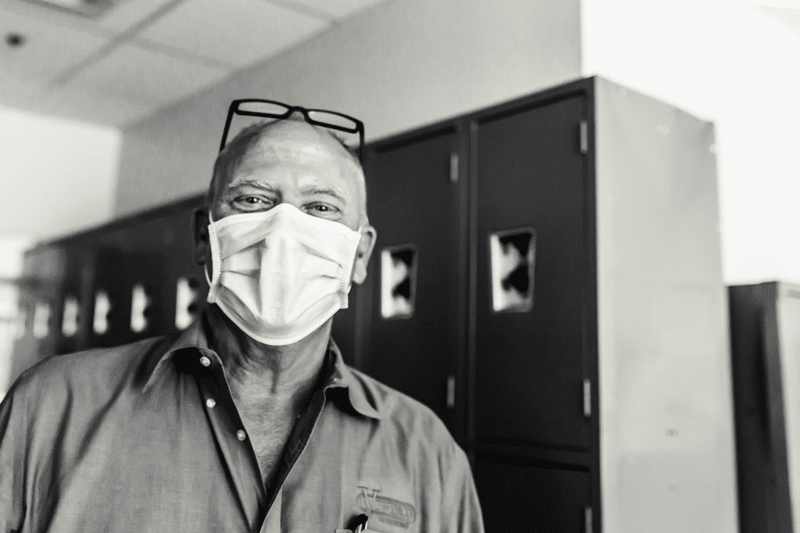 Black and white portrait of masked Viwinco employee.