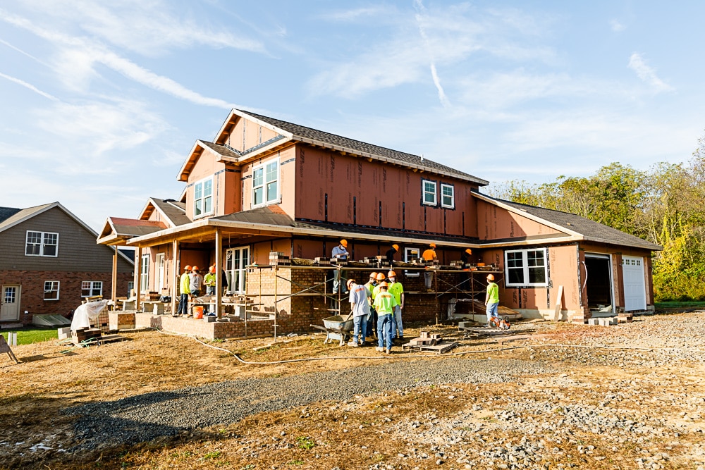 Wide-angle shot of BCTC student construction crew building home exterior