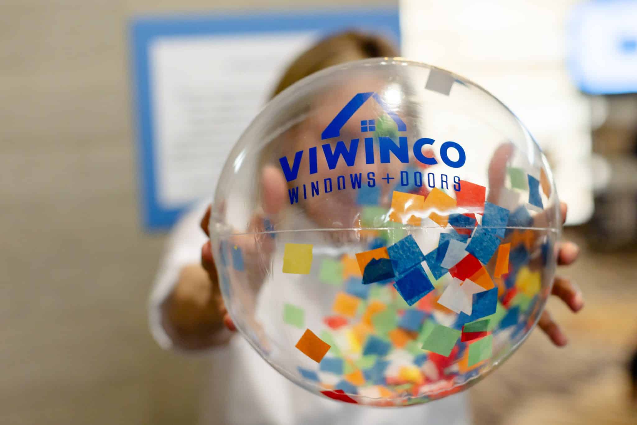 Woman holding Viwinco branded beachball